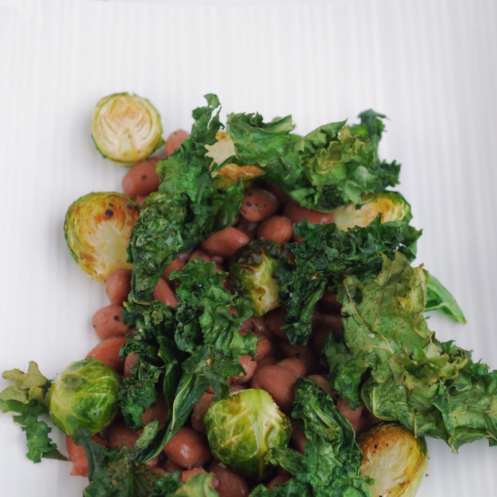 Kale & Pinto Beans: Crispy kale, creamy pinto beans, and sweet roasted brussels make up this play on a restaurant favorite! Filled with protein and vitamins, this healthy gluten free and vegan entrée is sure to satisfy! || fooduzzi.com