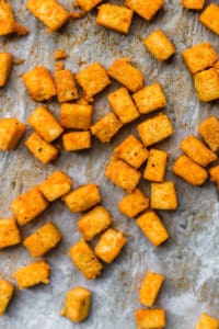 easy baked buffalo tofu on a baking sheet