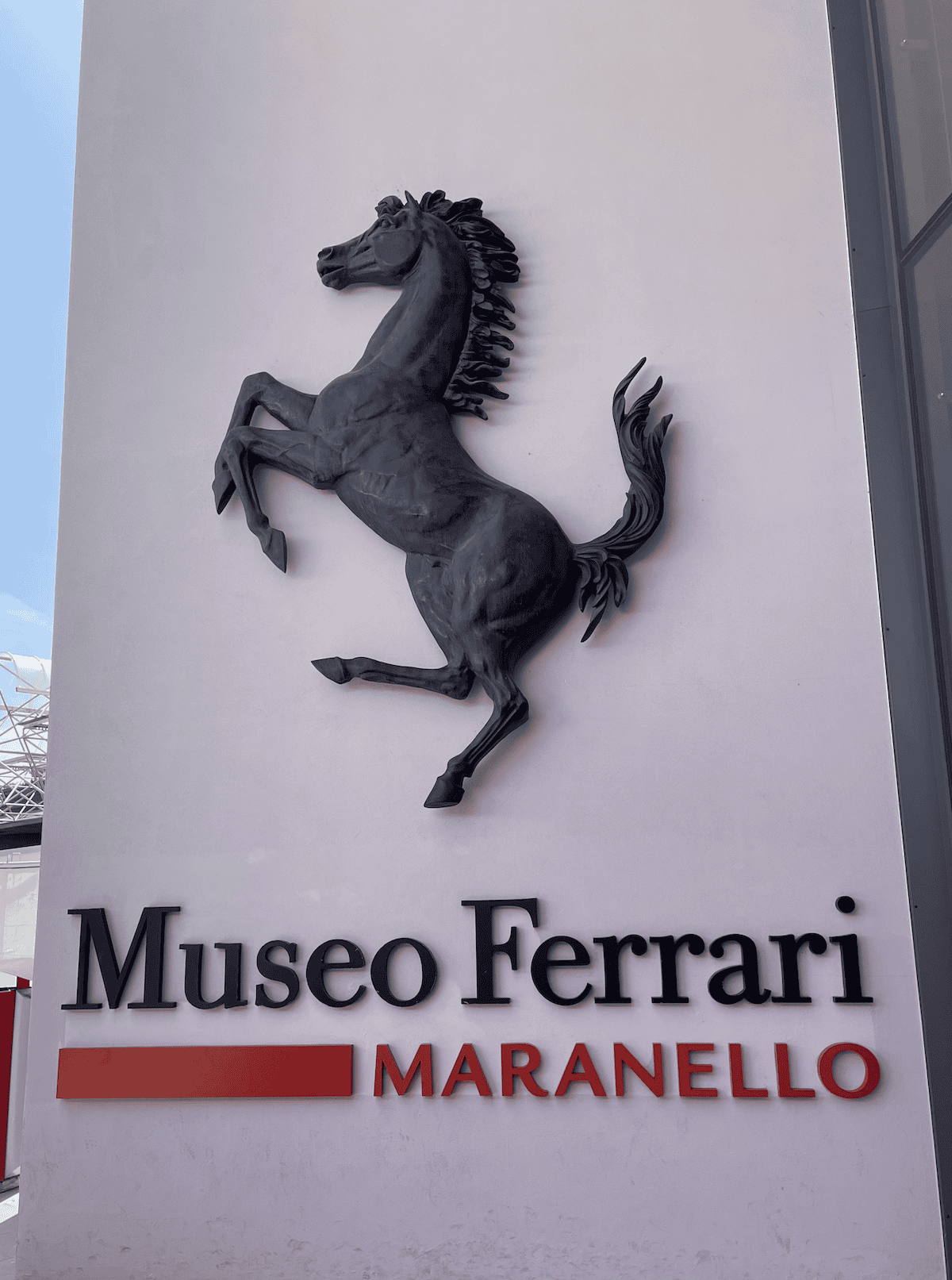 the prancing horse on a wall with the words 'museo ferrari maranello' on it
