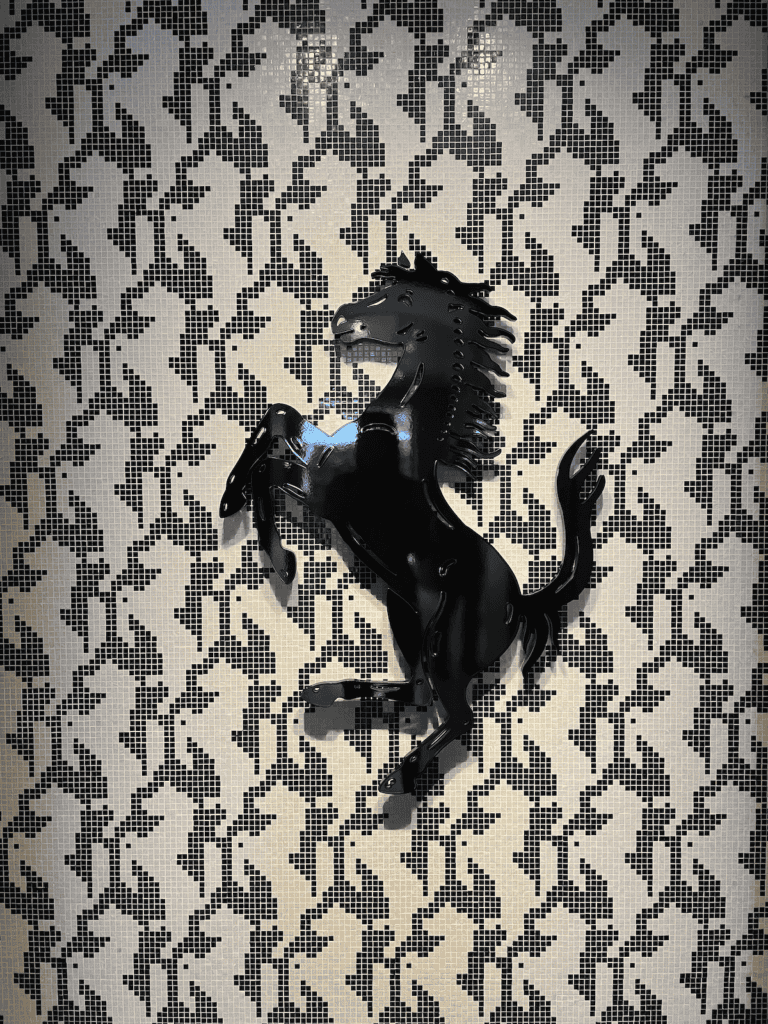 pixelated versions of the Ferrari prancing horse logo with a big black prancing horse on top