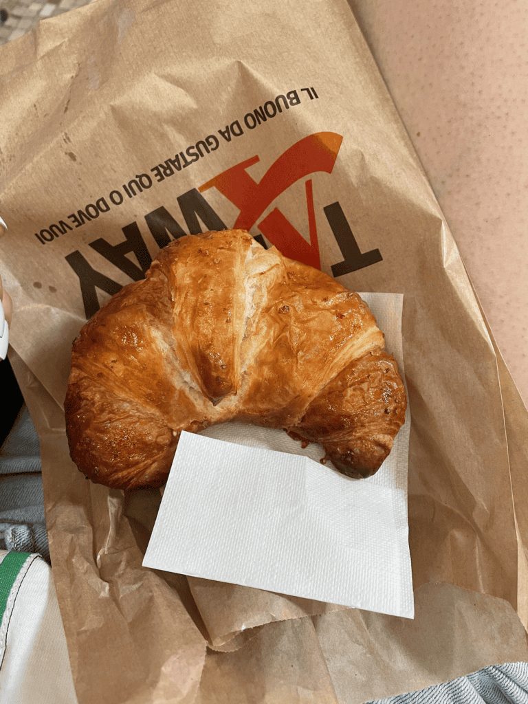 a croissant on a paper bag