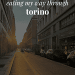a Torino street with the sun peaking through and the words 'eating my way through torino' on top