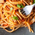 a fork twirling in pasta covered in a vegan/vegetarian mushroom bolognese